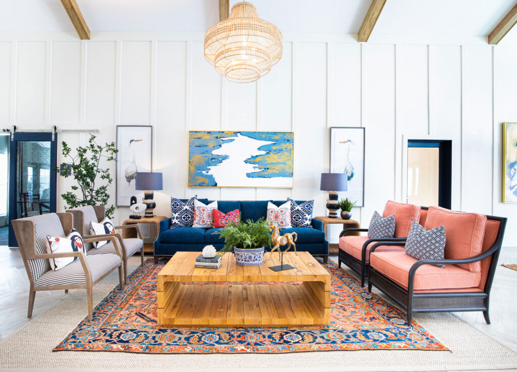 clubhouse lounge with couches, chairs, wall art, and chandelier
