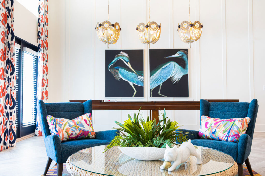 shuffleboard with paintings on the wall and chandeliers and view of seating area