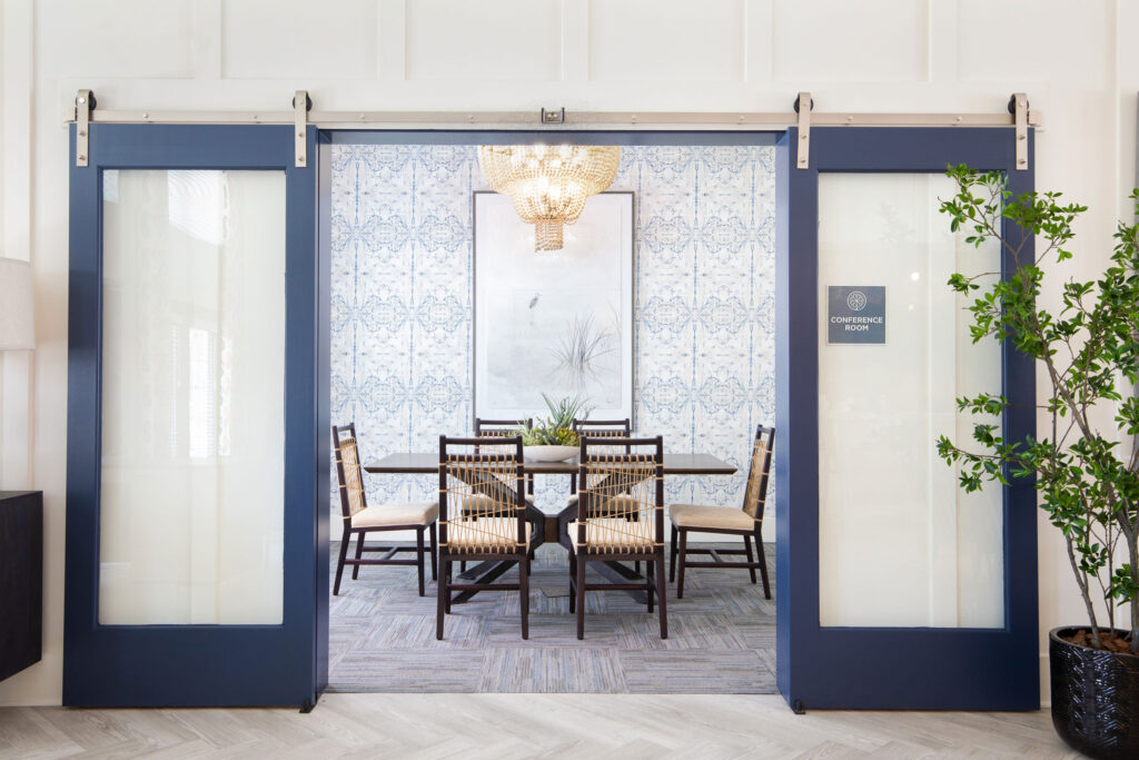 view of conference room with table, decor, and sliding barn doors