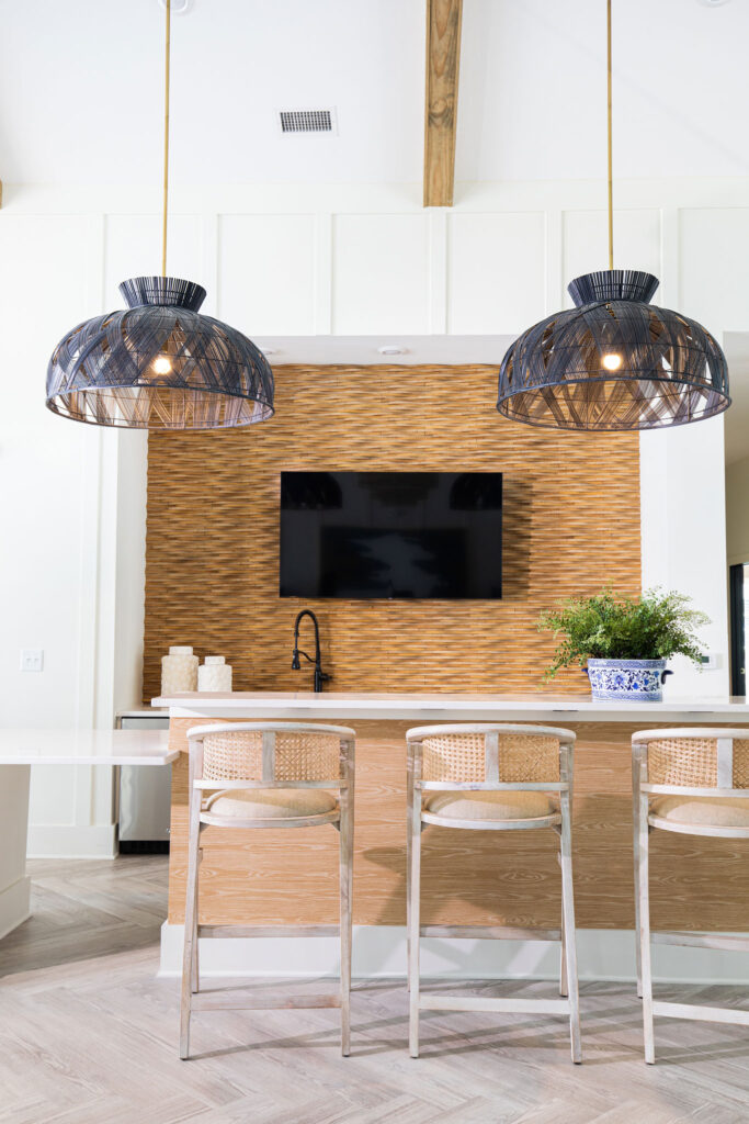 clubhouse kitchen with tv, bar, sink, and seating