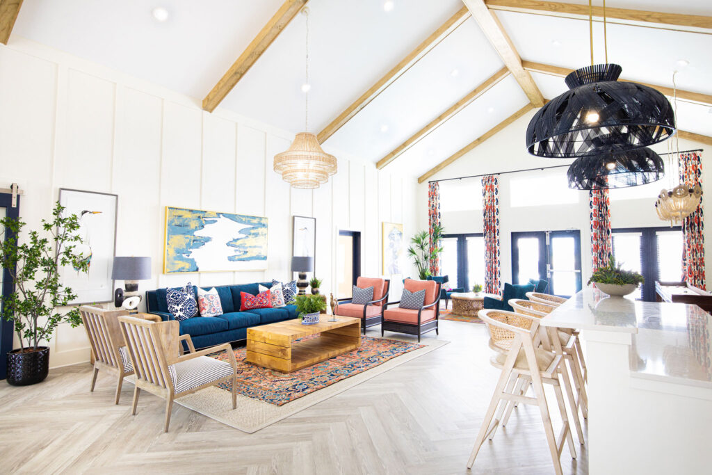clubhouse lounge with wall art, decor, view of the bar, and seating