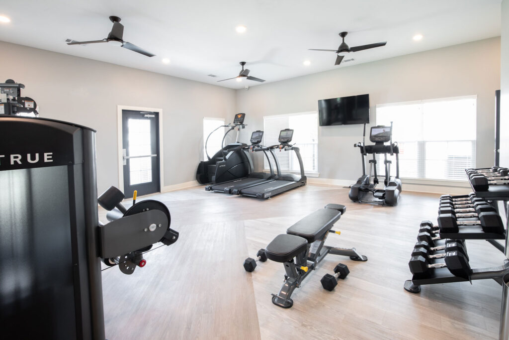 fitness center with tv's and equipment