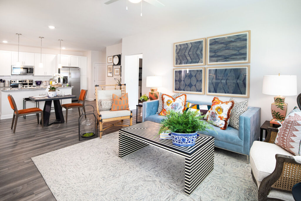 living room area with couches, chairs, decor, and view of dining and kitchen area