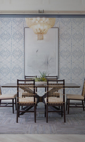 dining table with large art on all and chandelier