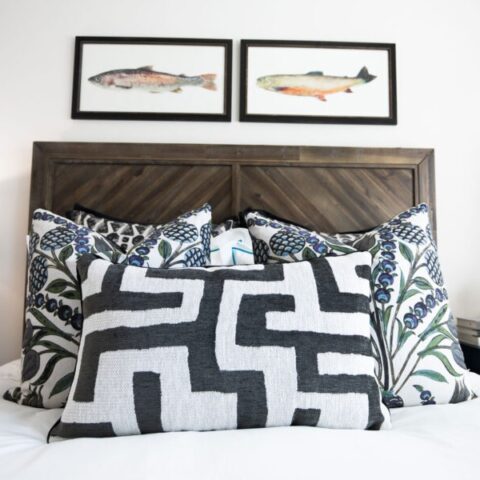 bed with decorative pillows and wall art